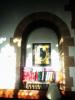 Framed image fixed to wall beneath an archway.