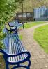 Two of a series of memorial seats in the garden and some of the memorial plaques to the left of the main memorial - family names include - McQuarrie, Bissett, Hollister, Buser, Halsch, Schultz