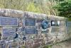 Examples of the wall mounted plaques to the right of the memorial - family names include, Curry, Giebler, Tsairis, Hunt, Lowenstein, Pierce, McKee, Corner and Akerstrom