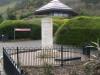 Stone pillar with plaque at base.