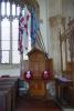 Triptych with flags flying above it. 