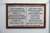 Wooden border around stone plaque with black inscription