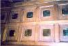 Wooden panel with brass plaques fixed to it.