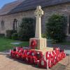 Celtic cross on base with plinth and poppy wreaths