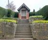 Landscaped steps leading to brick structure with timber roof