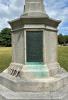 Base of memorial showing first world war plaque commemoration. Plaque is metal based with capital lettering