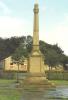 STONE OBELISK SURMOUNTING STONE PLINTH. PLINTH BEARS INSCRIPTION AND NAMES IN INCISED LETTERING. THREE-STEPPED STONE BASE.
