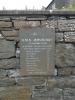 Stone tablet mounted on stone wall