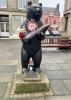 Statue of Wojtek with plaque and memorial bench behind