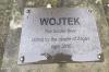 Metal plaque attached to foot of statue