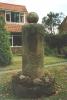 Rough plinth with circular base with orb on top