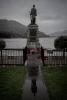 Figure atop granite plinth with plaque on side