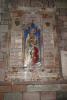 Stone tablet memorial with mosaic tile image inside cathedral