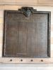 Large bronze plaque mounted on indoor wall. Inscribed are names of 'the men of Hamilton who have their lives 1914-1918'. A crest and insignia is atop the plaque. A decorative border surrounds three sides of the plaque.