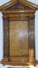 Wooden board with triangular pediment and gold letters