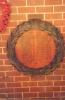 Two round dedicatory boards with wreath surround
