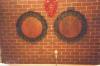 Two round dedicatory boards with wreath surround