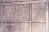 Wooden paneling in hall with inscribed names.