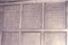 Wooden paneling in hall with inscribed names.