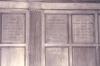 Wooden paneling in hall with inscribed names.