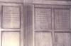 Wooden paneling in hall with inscribed names.