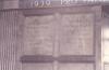 Wooden paneling in hall with inscribed names.