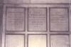 Wooden paneling in hall with inscribed names.