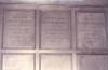 Wooden paneling in hall with inscribed names.