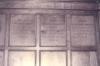 Wooden paneling in hall with inscribed names.