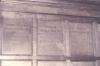 Wooden paneling in hall with inscribed names.
