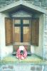 Wooden triptych set in stone niche with gold lettering