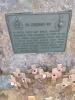 Bronze plaque with commemorative inscription on stone.