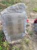 Stone of remembrance with three metal plaques with names