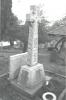 Rough hewn Celtic cross on base with names