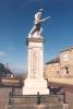 Statue of serviceman with rifle on pedestal with inscribed names