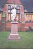 Sculpture of serviceman on rose stone pedestal