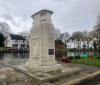 Cenotaph set on step bordering pond