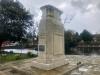 Cenotaph set on step bordering pond