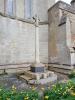 Memorial cross standing against church wall