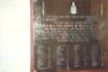 Brass plaque mounted on board, with inscription