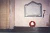 White marble tablet mounted onto a grey marble backboard