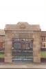 Memorial park with rectangular archway and iron gates