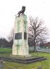 Sonte/cement pedestal with metal plaques on the sides and sculpture