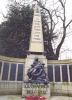 Composite memorial with plinth, relief, and metal plaques on a curved wall