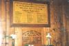 Two wall mounted wooden boards with inscription