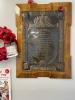 Memorial plaque attached to a wooden board
