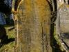 Leaded lettering on gravestone.