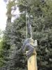 Allegory: Stone figure spearing a dragon, atop a square base and steps