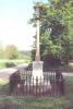 Cross on square plinth in small fenced area