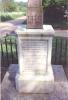 Cross on square plinth in small fenced area